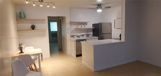 a kitchen with a refrigerator and a sink