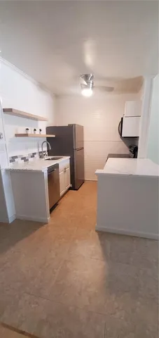 a living room with stainless steel appliances