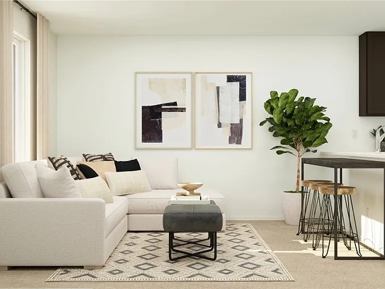 a living room with furniture a table and a potted plant
