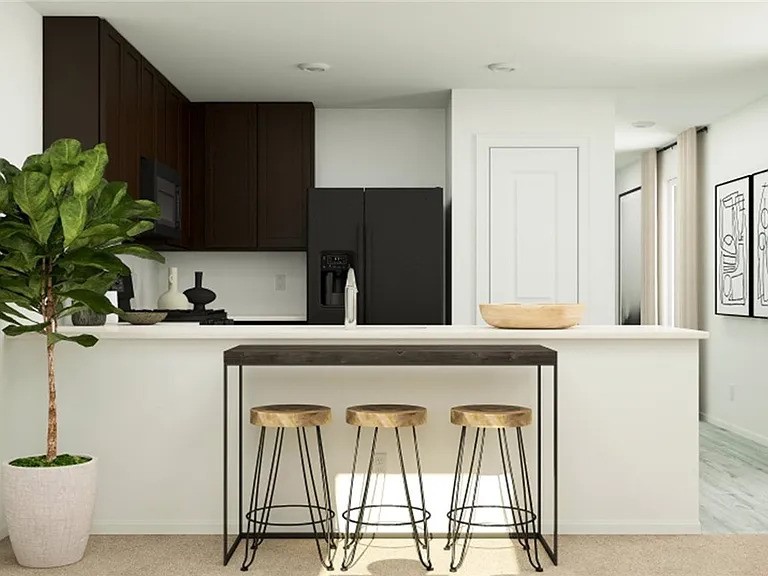 520 Commander Abbott Drive Jarrell, TX 76537 - Photo 4 of 10 a kitchen with a refrigerator a sink and wooden cabinets