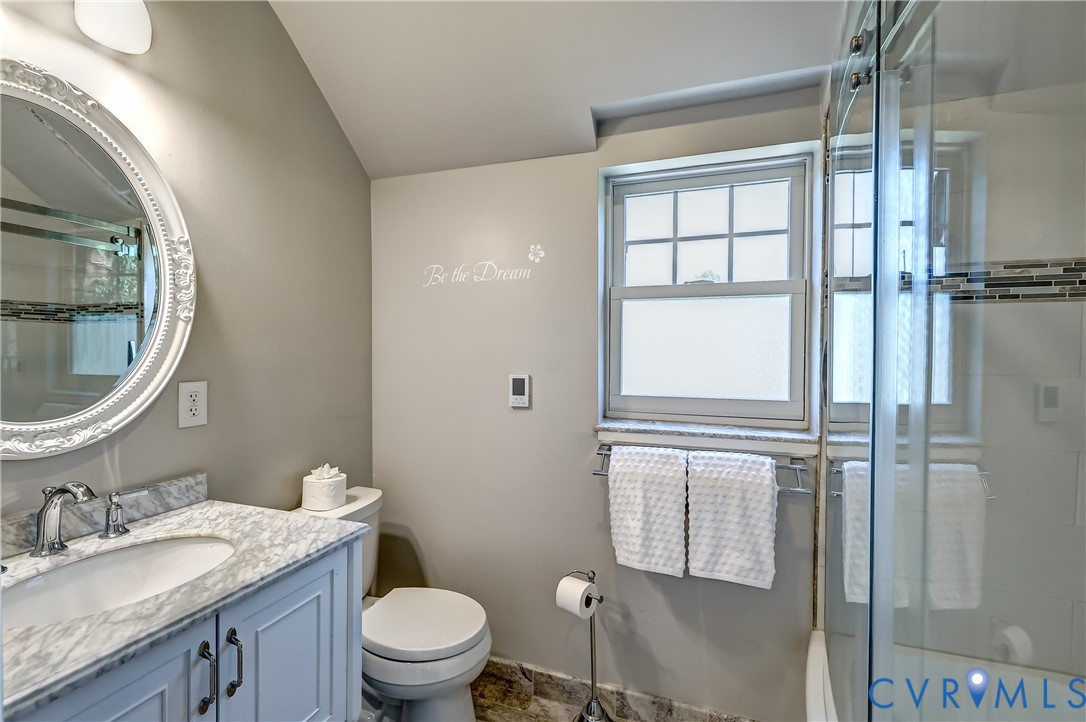 4814 Riverside Drive Richmond, VA 23225 - Photo 24 of 39 a bathroom with a granite countertop toilet a sink and a mirror