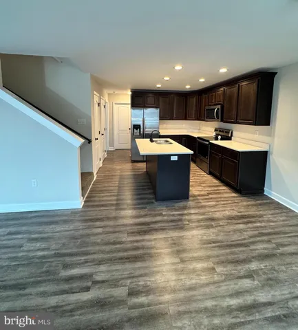 a kitchen with stainless steel appliances kitchen island granite countertop a large counter top and a stove