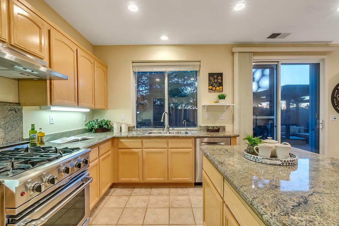 906 Schoolhouse Road San Jose, CA 95138 - Photo 13 of 57 a large kitchen with stainless steel appliances granite countertop a sink and cabinets