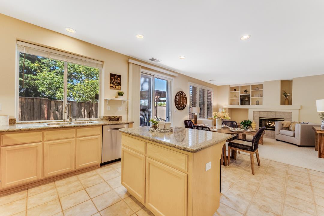 906 Schoolhouse Road San Jose, CA 95138 - Photo 15 of 57 a kitchen with sink cabinets and living room view