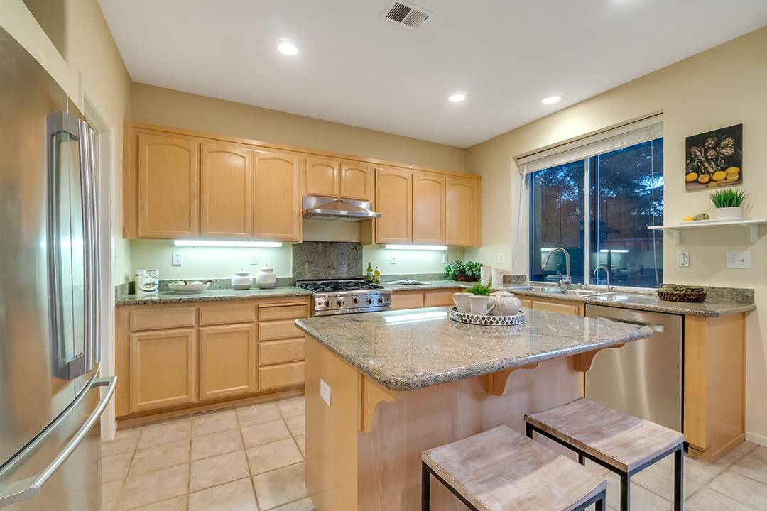 906 Schoolhouse Road San Jose, CA 95138 - Photo 16 of 57 a kitchen with stainless steel appliances granite countertop a stove refrigerator sink and cabinets