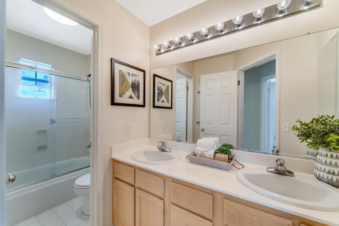906 Schoolhouse Road San Jose, CA 95138 - Photo 24 of 57 a bathroom with a double vanity sink toilet and shower
