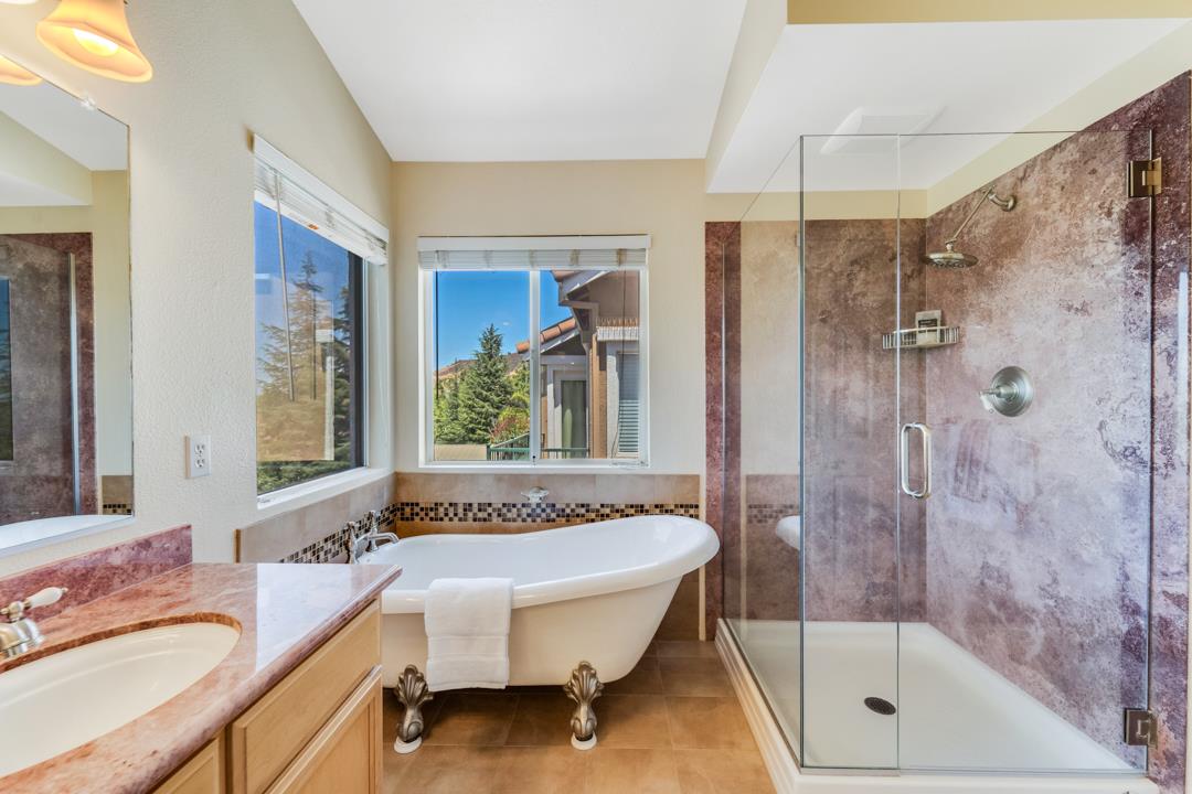 906 Schoolhouse Road San Jose, CA 95138 - Photo 34 of 57 a bathroom with a granite countertop tub sink and shower