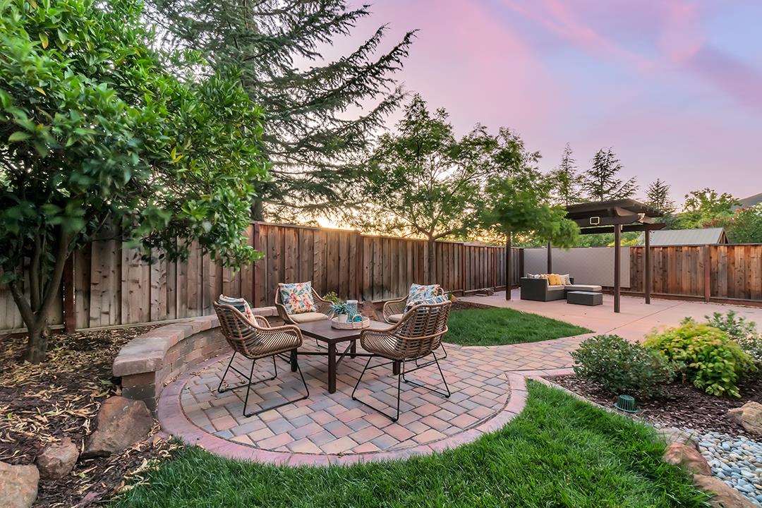906 Schoolhouse Road San Jose, CA 95138 - Photo 44 of 57 a view of a patio with table and chairs potted plants and wooden fence
