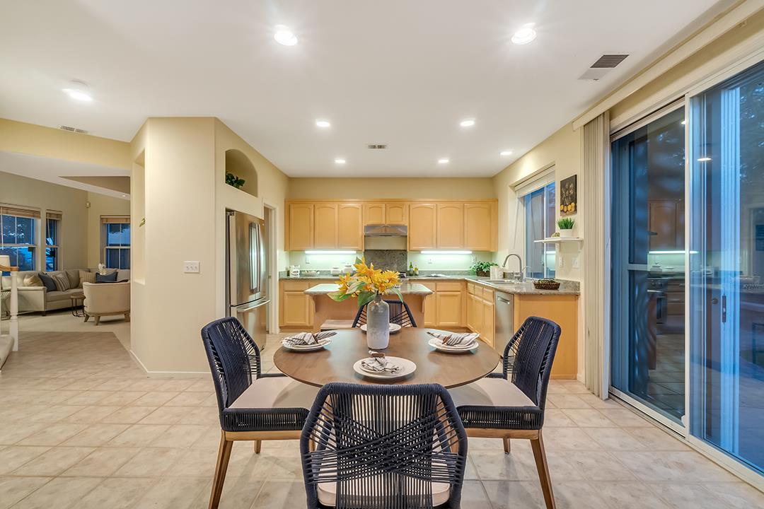 906 Schoolhouse Road San Jose, CA 95138 - Photo 10 of 57 a dining room with stainless steel appliances a dining table and chairs