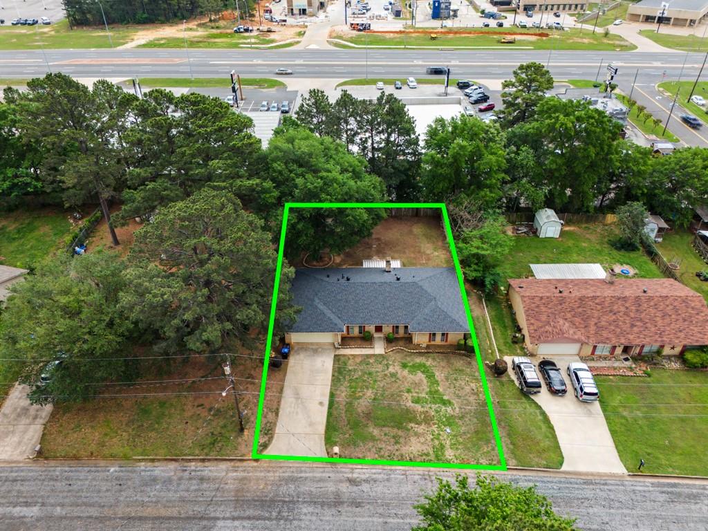 an aerial view of a house with swimming pool and a yard