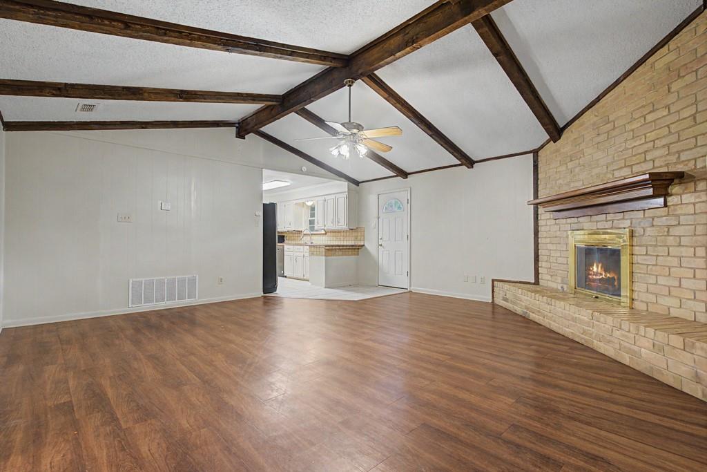 2104 Wainwright Court Longview, TX 75605 - Photo 17 of 31 a view of empty room with wooden floor and fireplace
