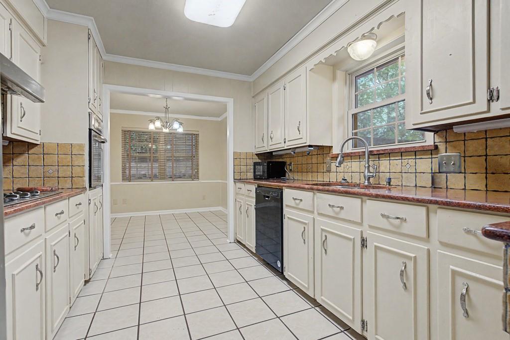2104 Wainwright Court Longview, TX 75605 - Photo 25 of 31 a kitchen with white cabinets a sink dishwasher and a stove with wooden floor