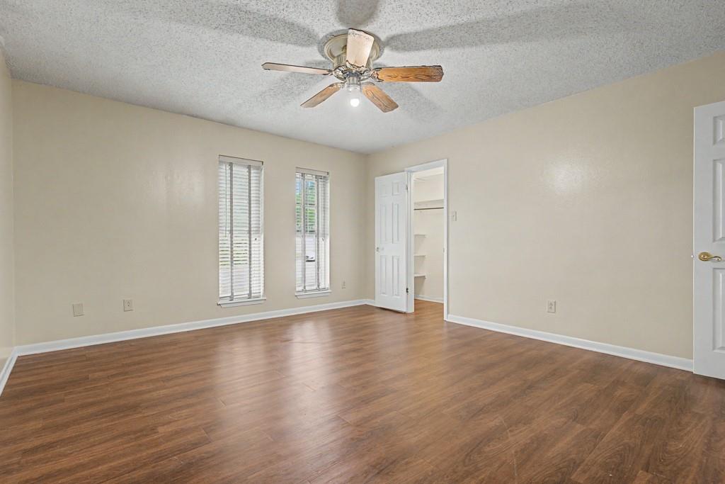 2104 Wainwright Court Longview, TX 75605 - Photo 7 of 31 a view of an empty room with window and wooden floor