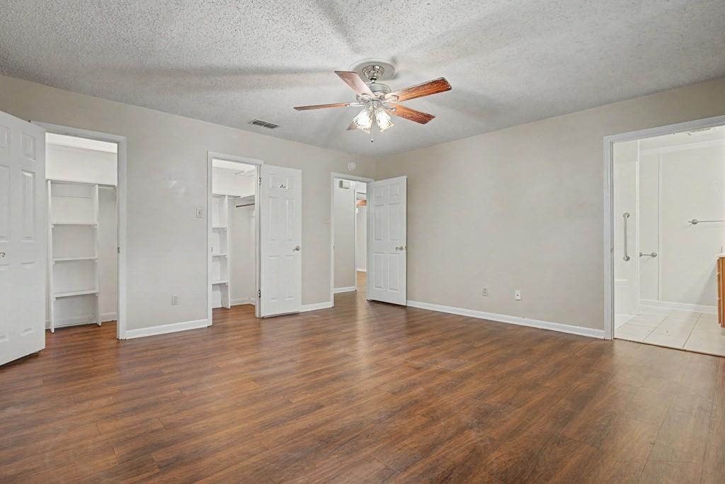 2104 Wainwright Court Longview, TX 75605 - Photo 8 of 31 an empty room with wooden floor and windows