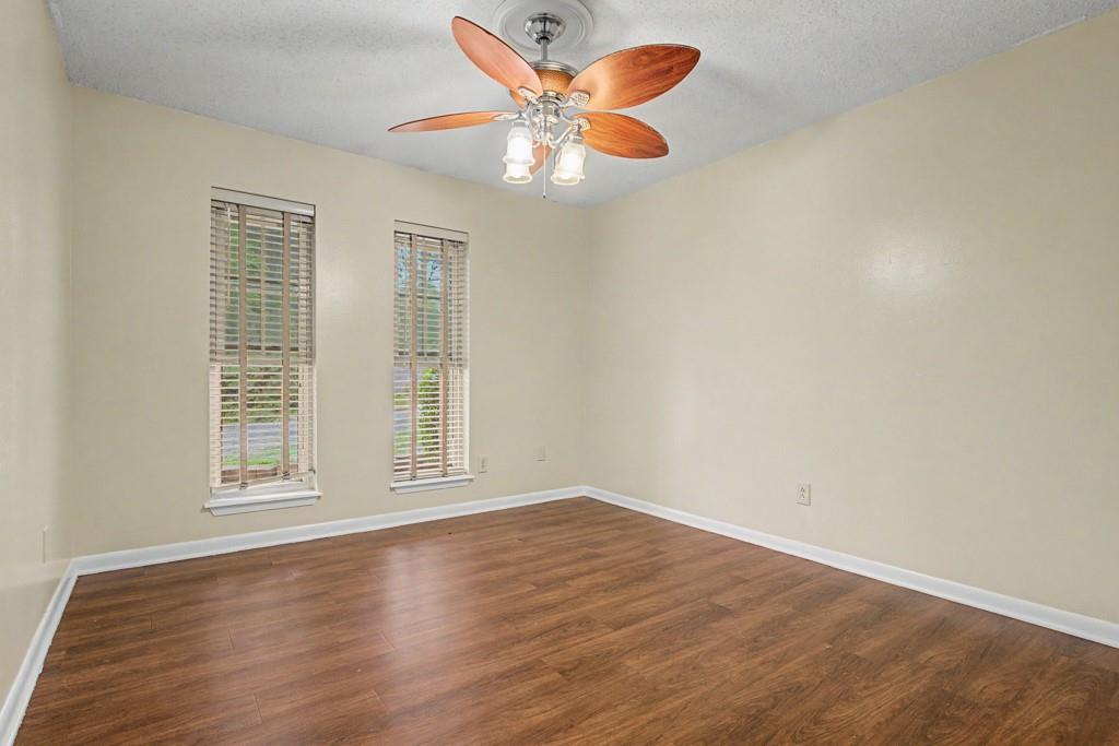 2104 Wainwright Court Longview, TX 75605 - Photo 10 of 31 a view of an empty room with window and wooden floor