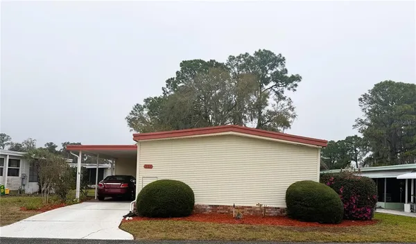 a view of a house with a yard and garage