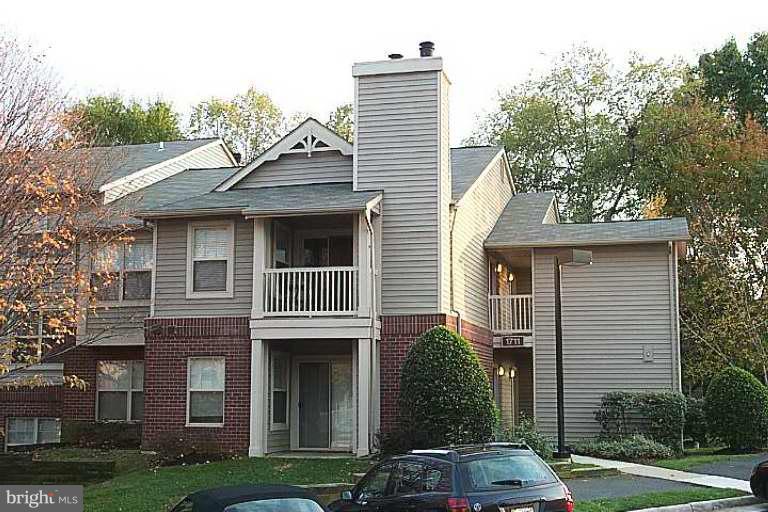 1711 Ascot Way, Unit B Reston, VA 20190 - Photo 1 of 1 a view of multiple houses with a yard