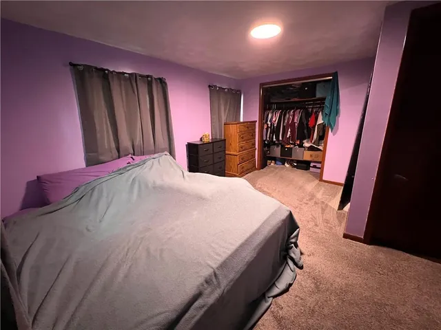 a bed sitting in a room next to a window