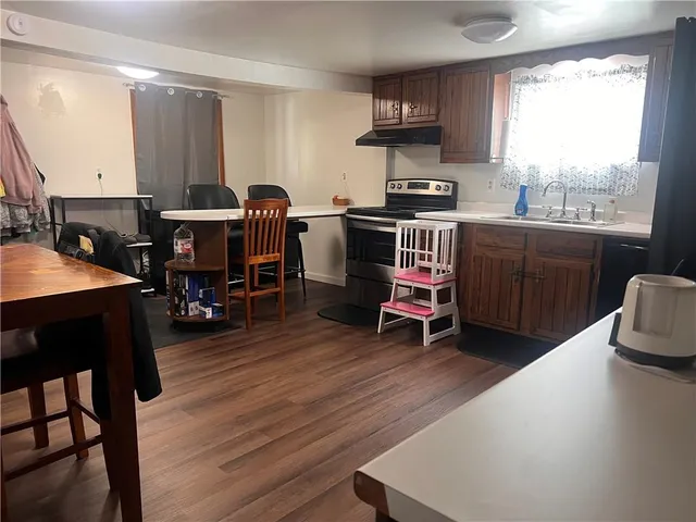 a workspace with furniture window and wooden floor