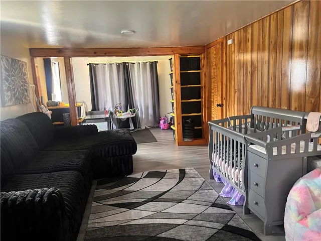 a living room with furniture and large windows