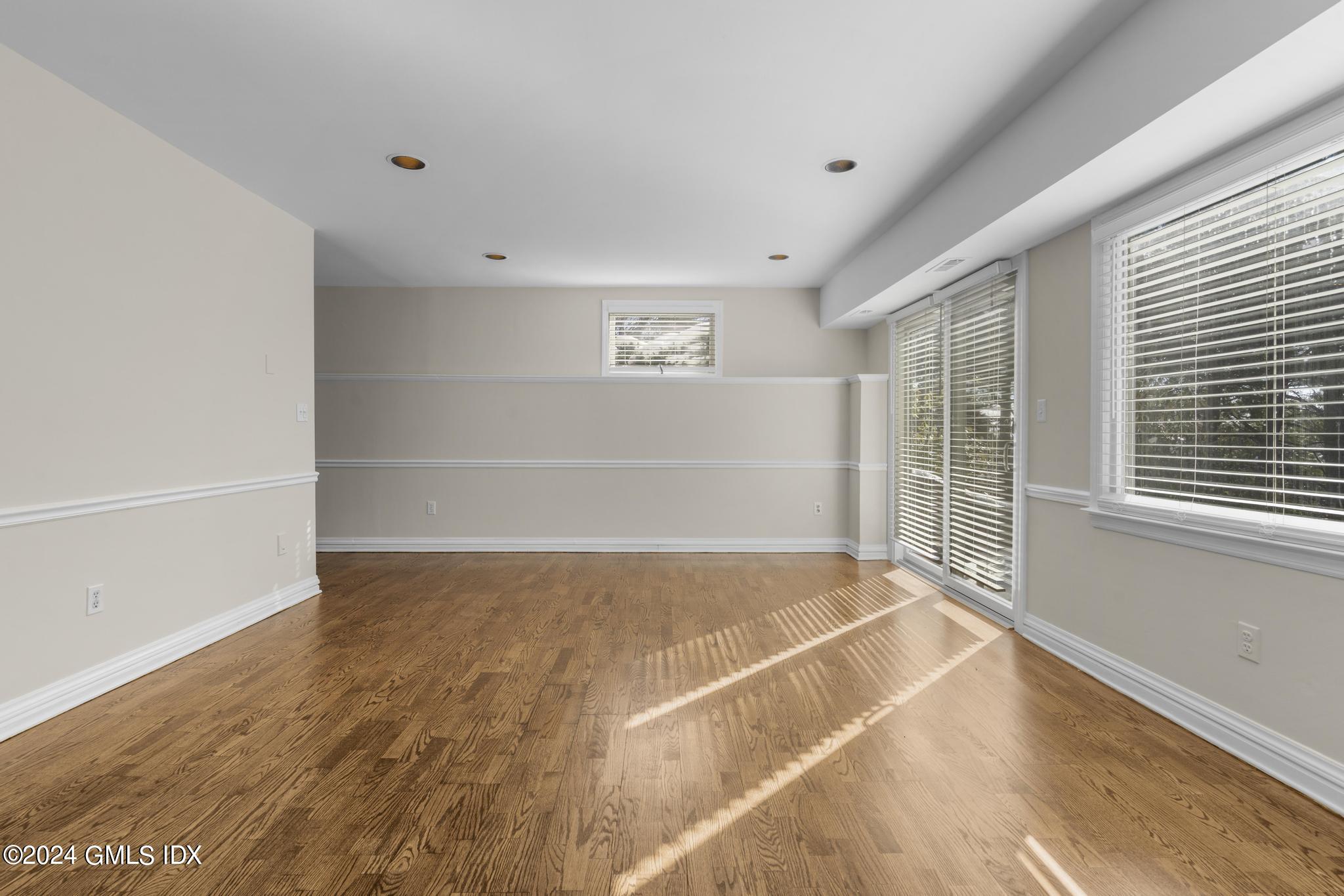 172 Field Point Road, Unit 1 Greenwich, CT 06830 - Photo 25 of 36 a view of an empty room with wooden floor and a window