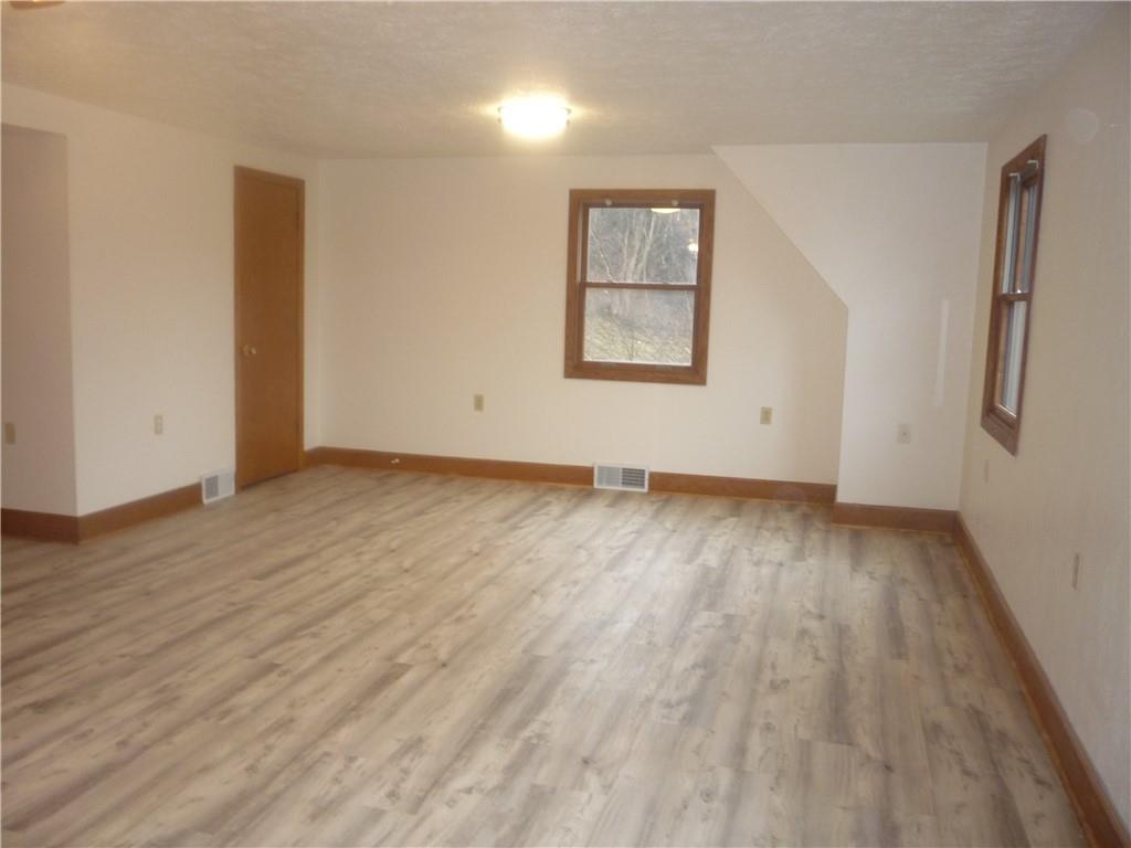 4465 Mt Troy Rd Extension, Unit 2 Pittsburgh, PA 15214 - Photo 15 of 36 an empty room with wooden floor and windows