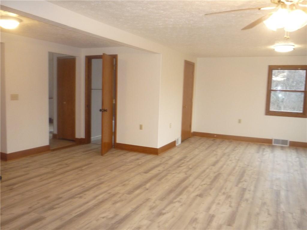 4465 Mt Troy Rd Extension, Unit 2 Pittsburgh, PA 15214 - Photo 17 of 36 an empty room with wooden floor and windows