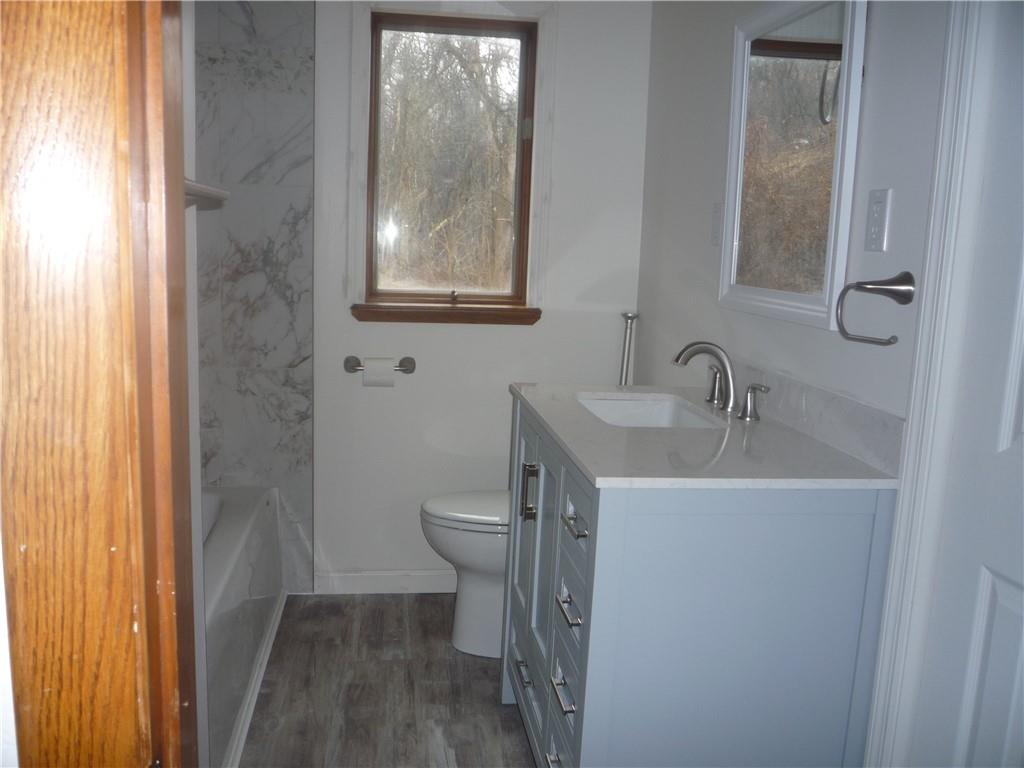4465 Mt Troy Rd Extension, Unit 2 Pittsburgh, PA 15214 - Photo 20 of 36 a bathroom with a sink toilet and vanity