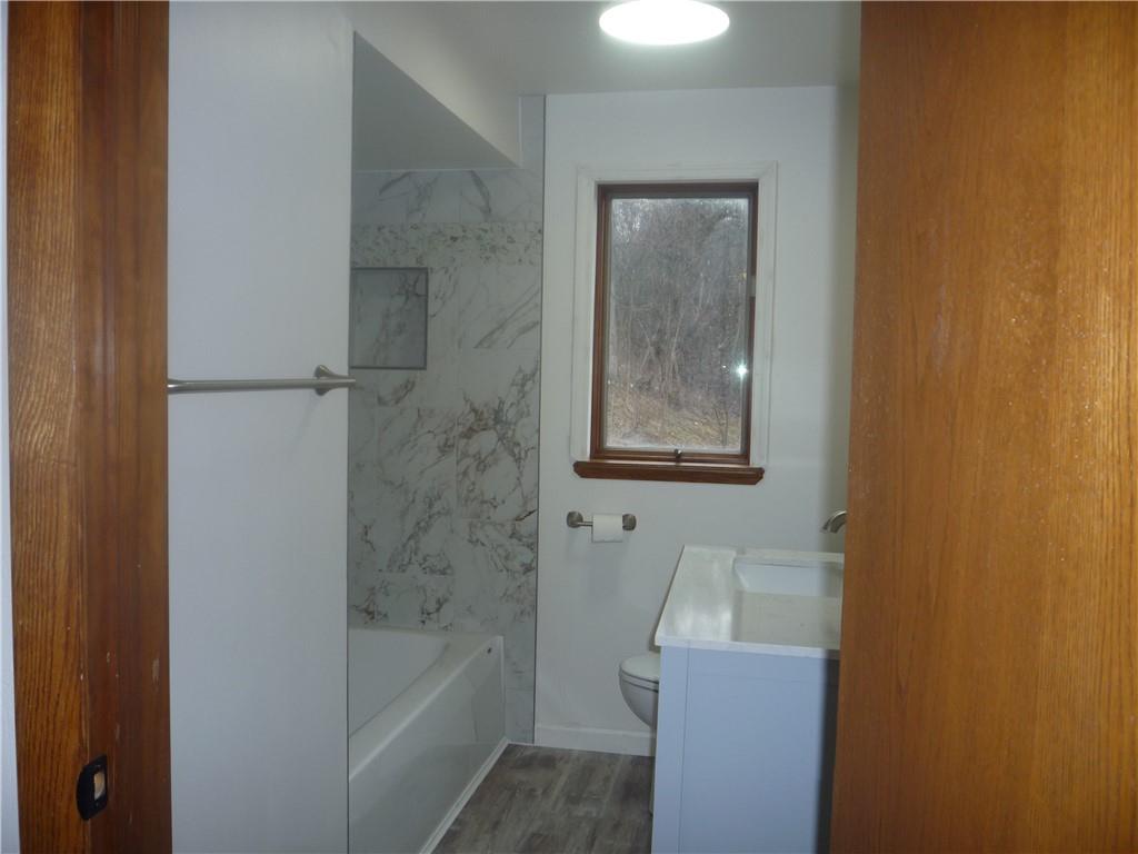 4465 Mt Troy Rd Extension, Unit 2 Pittsburgh, PA 15214 - Photo 21 of 36 a bathroom with a tub shower and sink