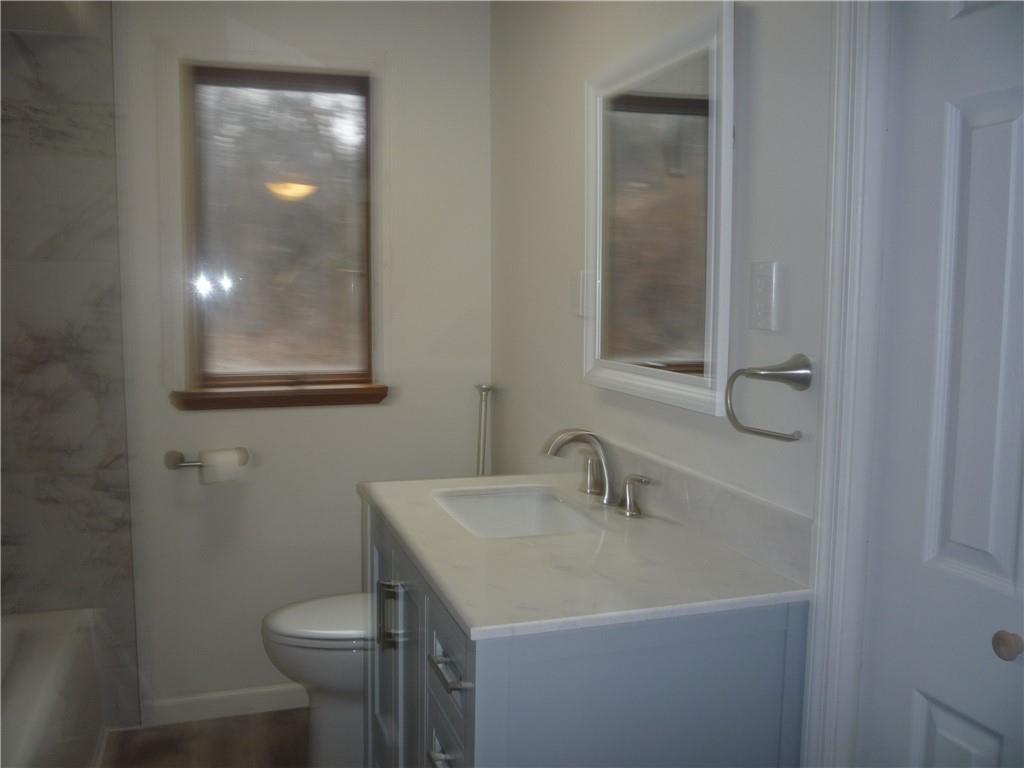 4465 Mt Troy Rd Extension, Unit 2 Pittsburgh, PA 15214 - Photo 22 of 36 a bathroom with a sink toilet and mirror