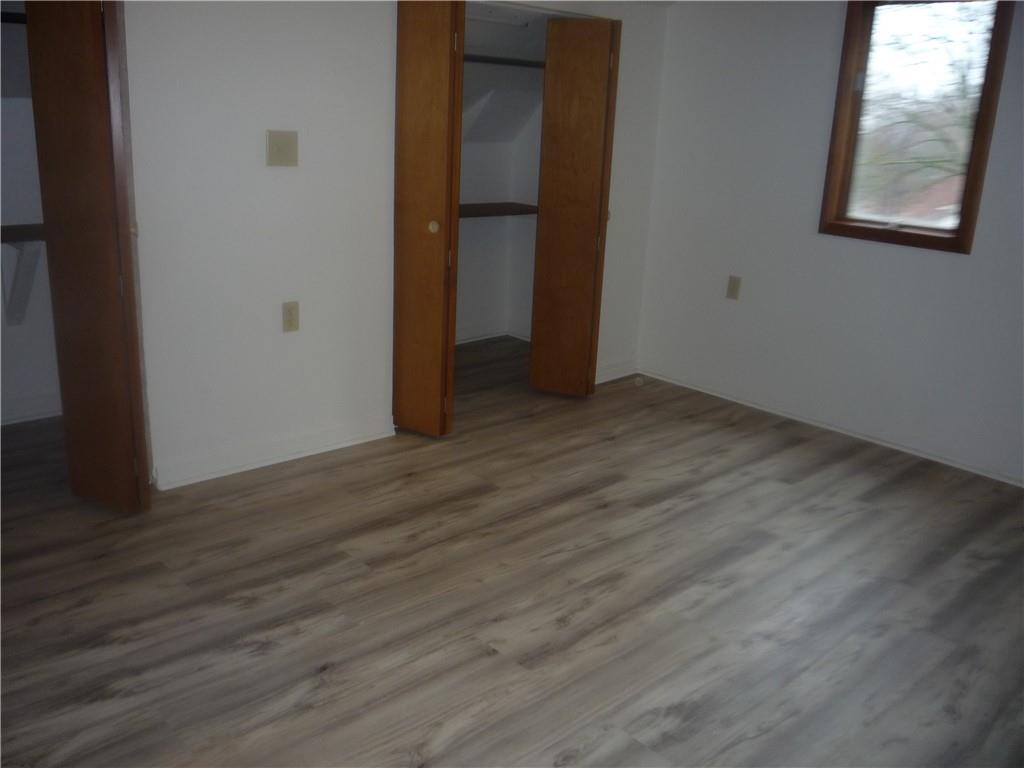 4465 Mt Troy Rd Extension, Unit 2 Pittsburgh, PA 15214 - Photo 30 of 36 an empty room with wooden floor and windows