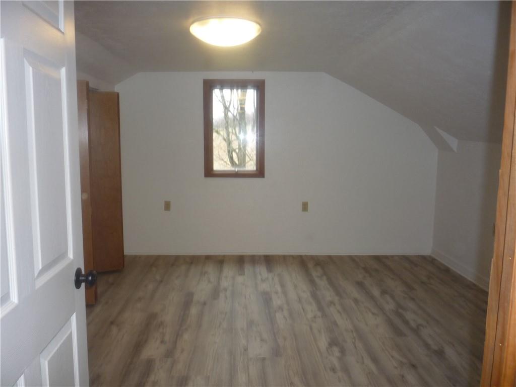 4465 Mt Troy Rd Extension, Unit 2 Pittsburgh, PA 15214 - Photo 31 of 36 an empty room with wooden floor and windows