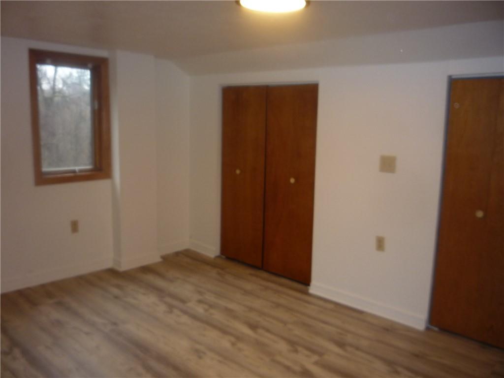 4465 Mt Troy Rd Extension, Unit 2 Pittsburgh, PA 15214 - Photo 32 of 36 an empty room with wooden floor and closet