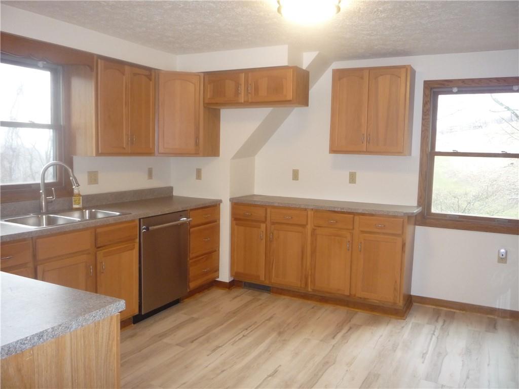 4465 Mt Troy Rd Extension, Unit 2 Pittsburgh, PA 15214 - Photo 9 of 36 a kitchen with a sink a window and cabinets
