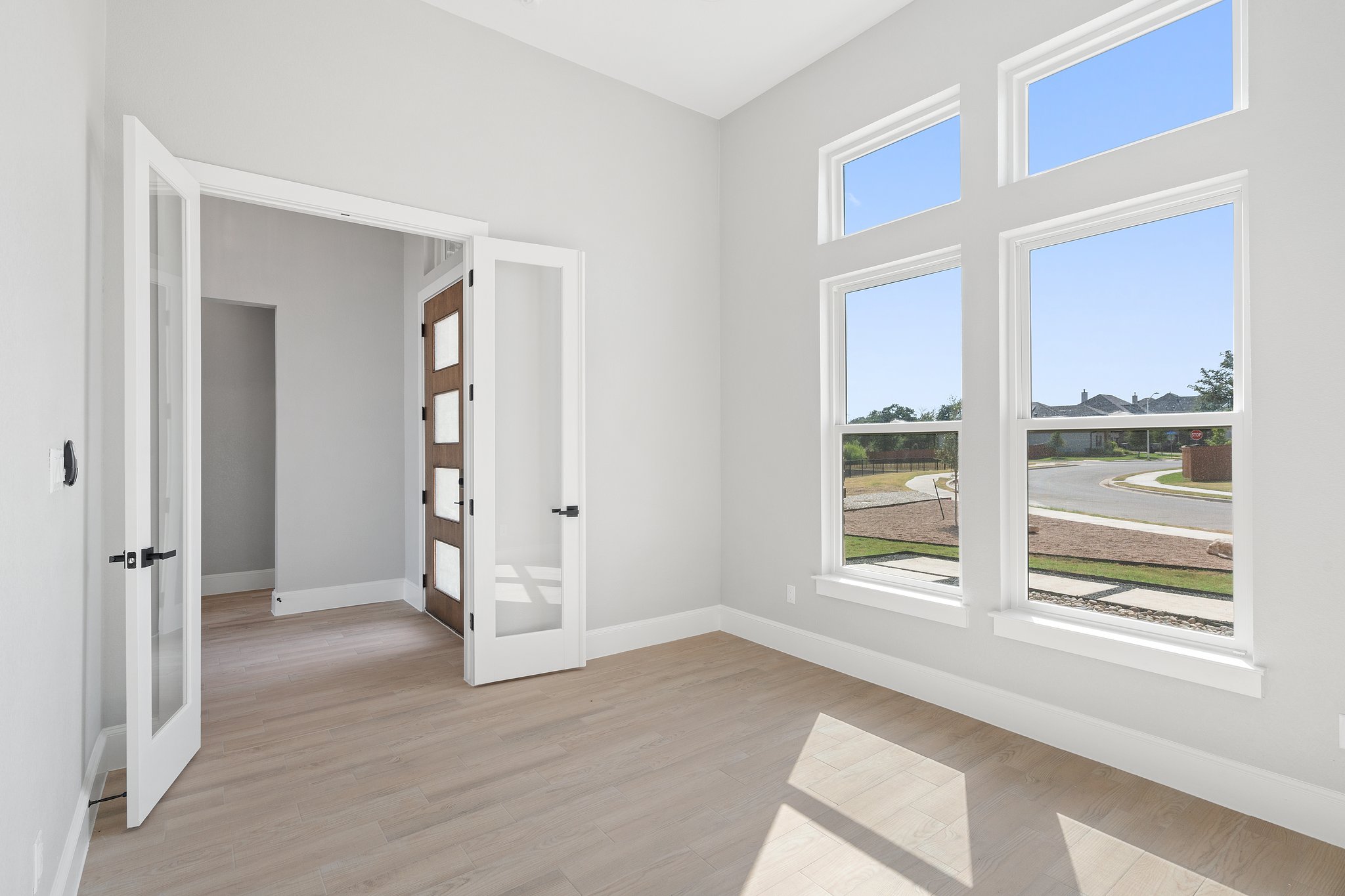 308 Axis Loop Georgetown, TX 78628 - Photo 4 of 40 a view of an empty room with wooden floor and windows