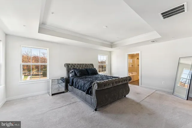 a spacious bedroom with a bed and a window