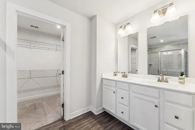 a bathroom with a double vanity sink and mirror