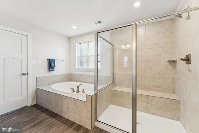 a bathroom with a bathtub and a shower