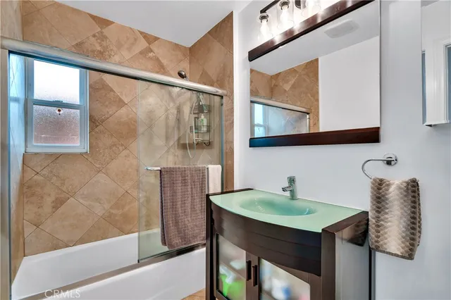 a bathroom with a sink a mirror and a shower