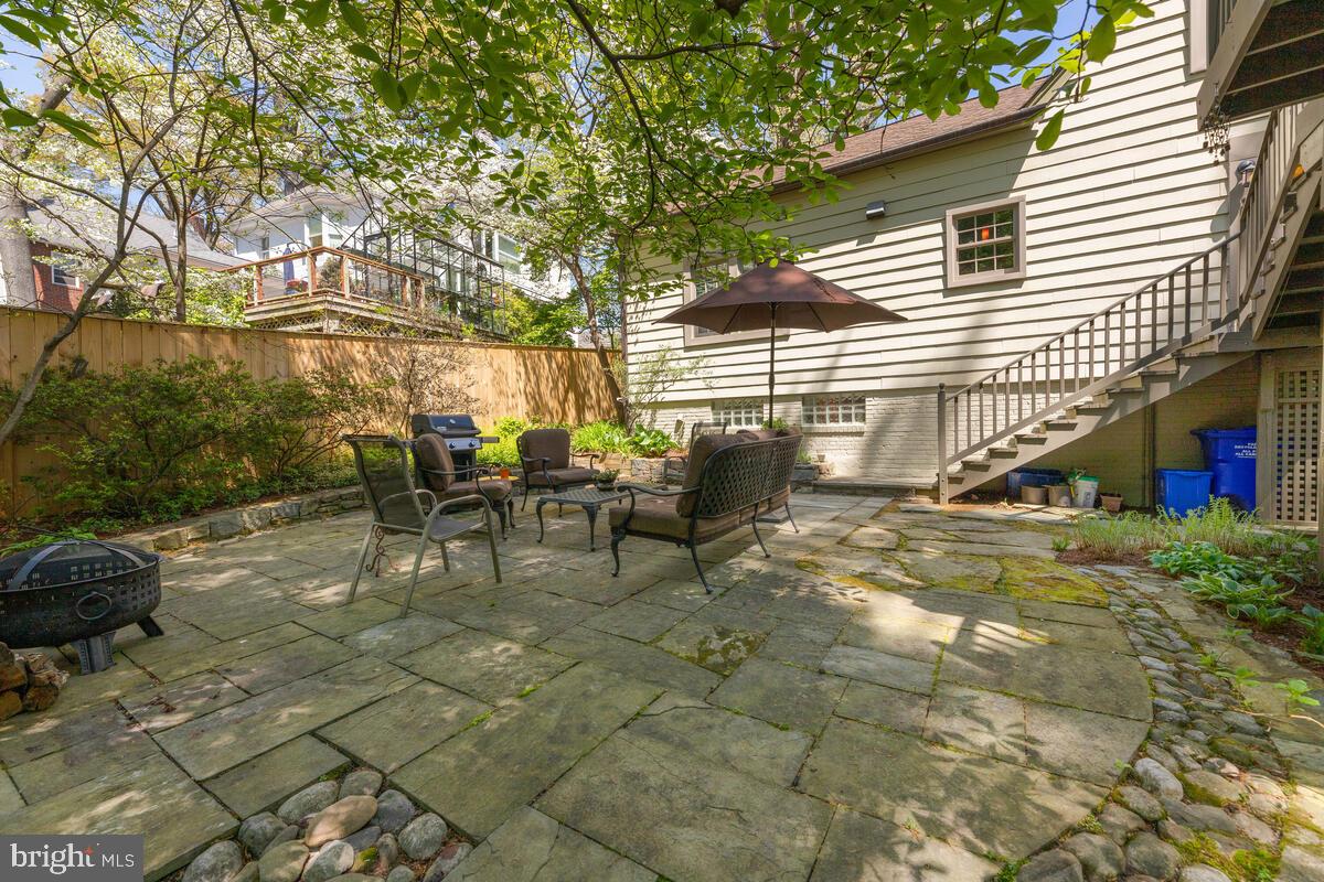17 Sunnyside Road Silver Spring, MD 20910 - Photo 42 of 50 a view of a patio with table and chairs and potted plants