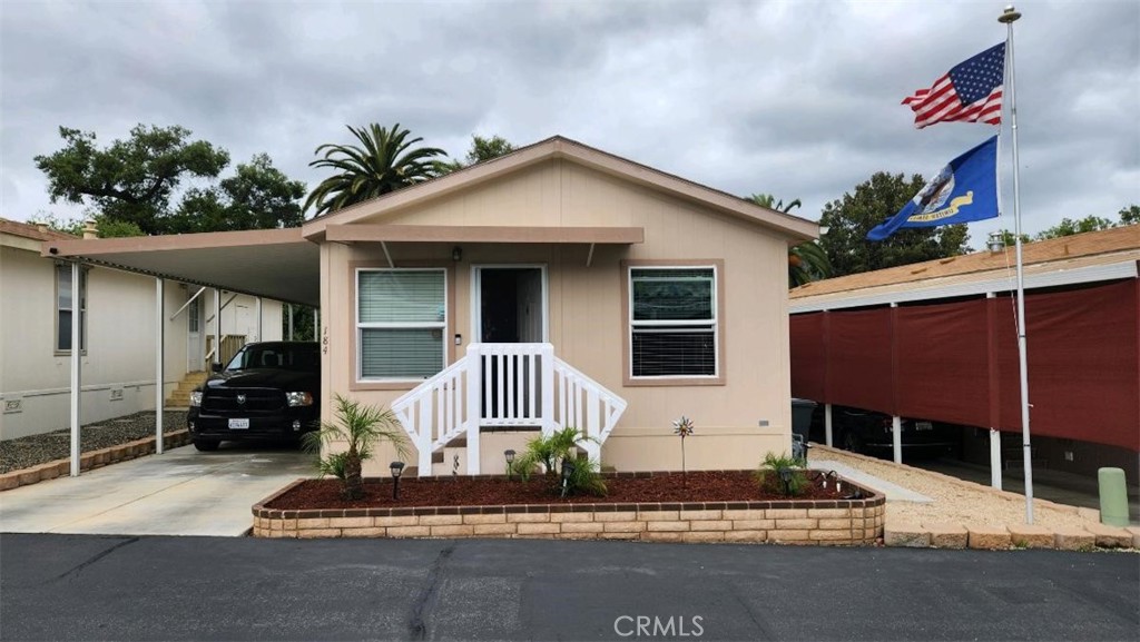 3909 Reche Road, Unit 184 Fallbrook, CA 92028 - Photo 1 of 1 a front view of a house with garden