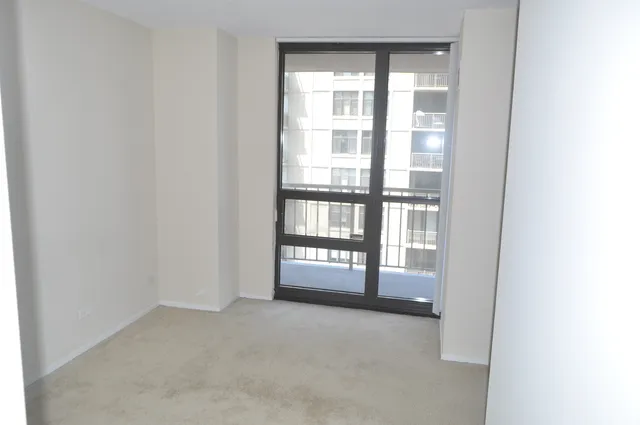 a view of an empty room and a window