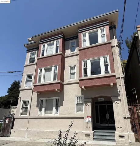 a view of a kitchen with wooden floor and a window
