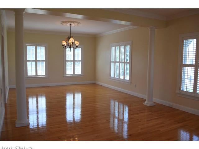 a hallway with a window and wooden floor