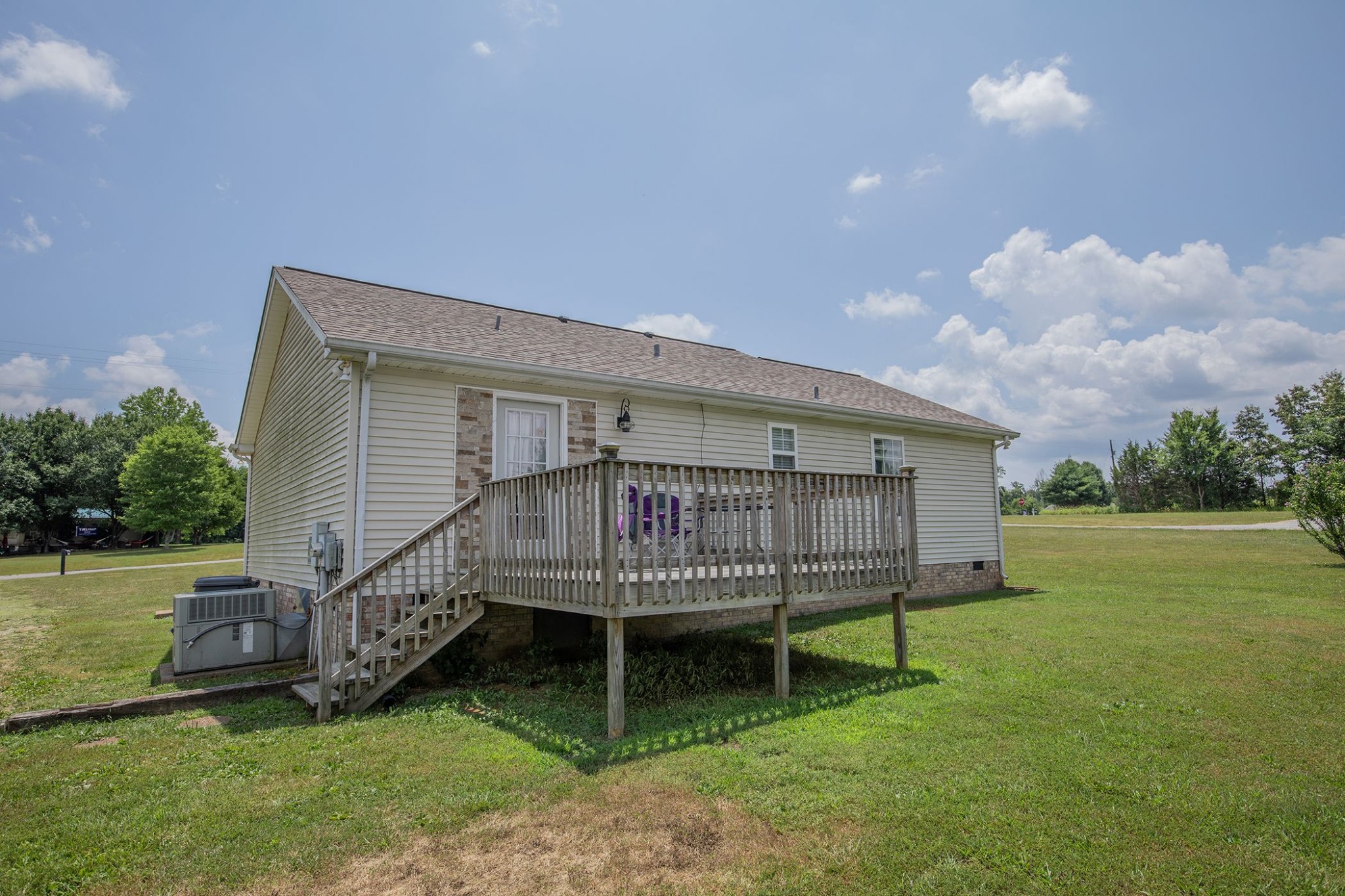 207 Hester Road Portland, TN 37148 - Photo 14 of 41 a view of a house with a backyard and a wooden deck