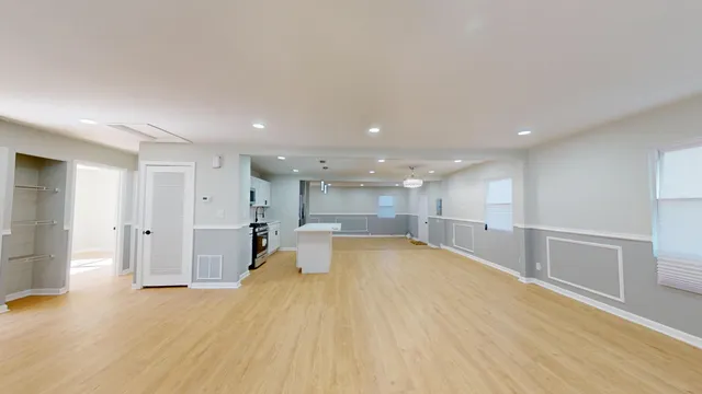 a view of a kitchen with a sink and cabinets