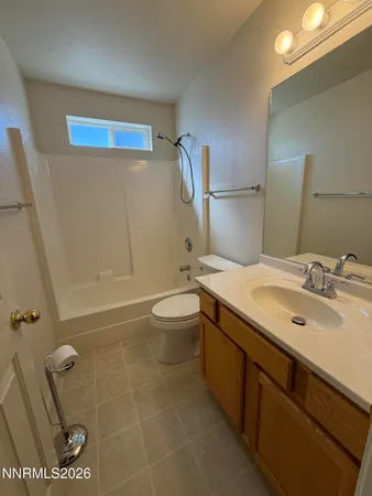 a bathroom with a double vanity sink toilet mirror and shower