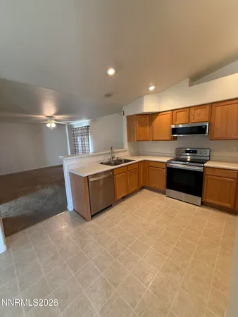 a large kitchen with stainless steel appliances granite countertop a sink and stove top oven