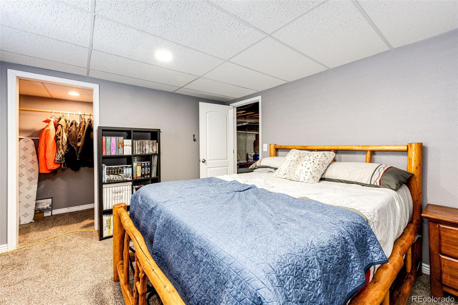 570 4th Street Bennett, CO 80102 - Photo 27 of 36 a bedroom with a bed and a book shelf