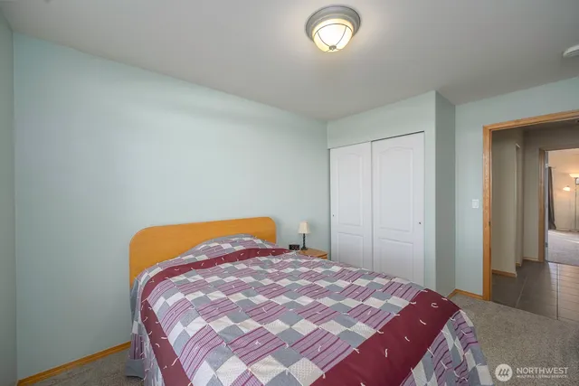 a bedroom with a bed and a closet